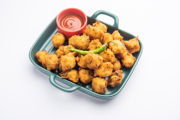 Moong Dal Vada o mungode Pakoda, Dalwada, Pakora o Mungdal Bhajiya o frittelle Yellow Split Gram servite con ketchup di pomodoro