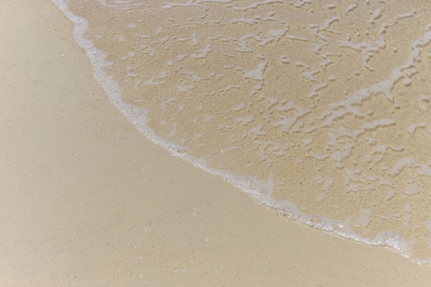 Morbida onda del mare sullo sfondo spiaggia di sabbia