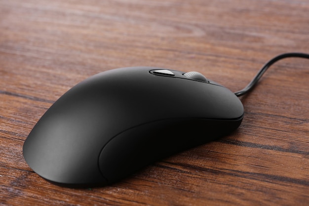 Mouse del computer con cavo su sfondo di legno