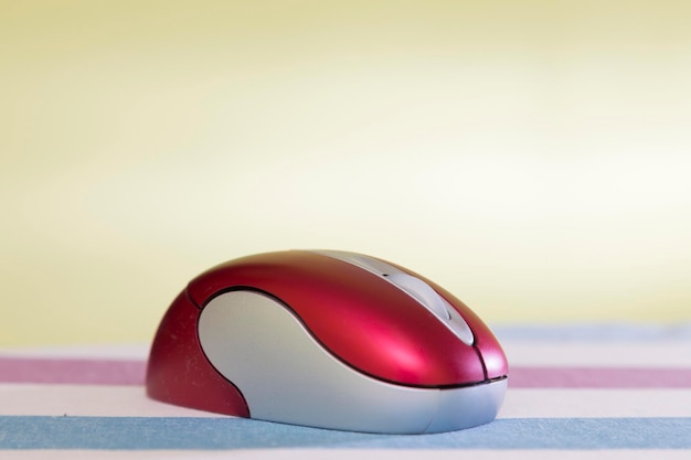 Mouse rosso inhalambrico per computer arroccato su una superficie rigata