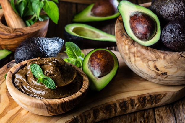 Mousse al cioccolato con avocado in ciotola di legno d'ulivo