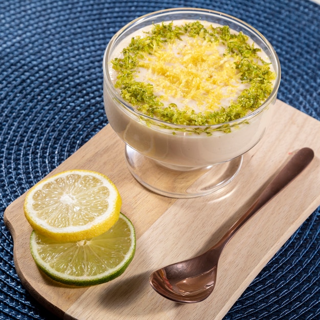 Mousse al limone in coppa di cristallo con scorza di limone.