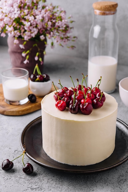 Mousse di cheesecake alla vaniglia con ciliegie su piatto nero