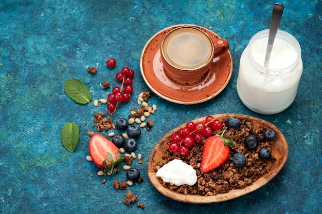 Muesli muesli tazza di caffè yogurt e frutti di bosco freschi colazione sana