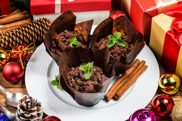 Muffin al cioccolato e rami di abete. Periodo natalizio.