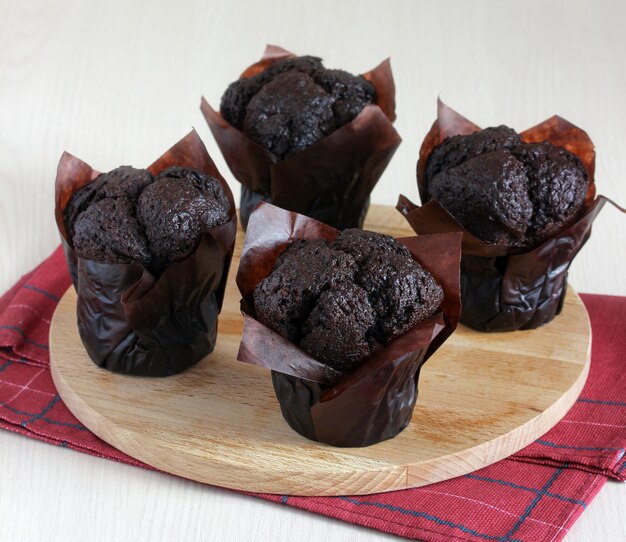 Muffin al cioccolato freschi dolci da dessert con farina sul tavolo