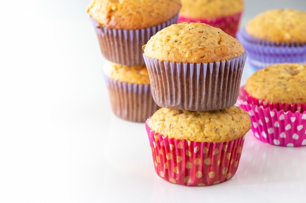 Muffin al limone fatti in casa con caramelle colorate al cioccolato in astuccio di carta e tazza di tè