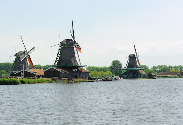 Mulino a vento olandese tradizionale vicino al canale nel giorno di estate. Olanda