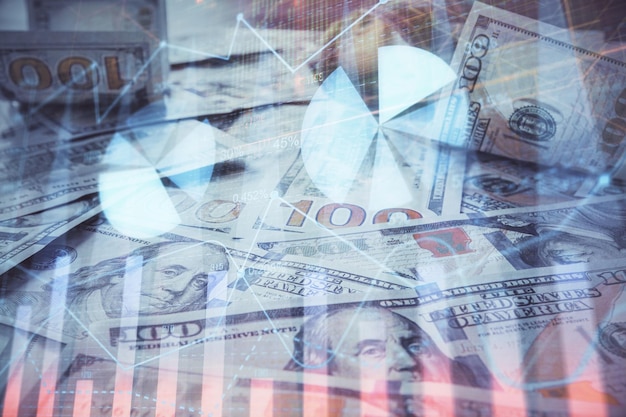 Multi esposizione del grafico forex che disegna sullo sfondo della banconota in dollari statunitensi Il concetto di mercati di successo finanziario