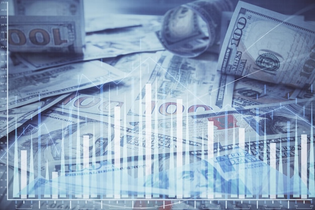 Multi esposizione del grafico forex che disegna sullo sfondo della banconota in dollari statunitensi Il concetto di mercati di successo finanziario