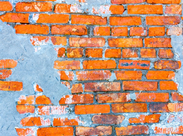 Muro della casa, il muro di mattoni rossi di una casa abbandonata. sfondo