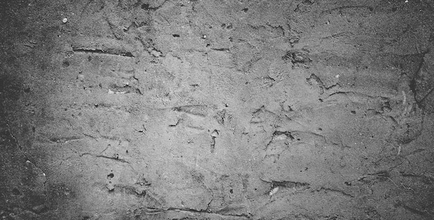 Muro di cemento nero o sfondo grigio scuro con struttura in pietra granulosa