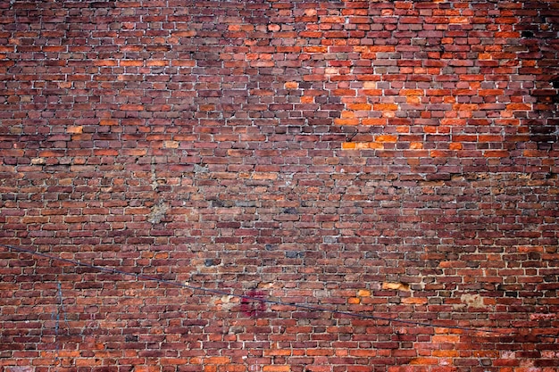 Muro di lerciume di struttura del mattone come superficie di pietra alterata del fondo