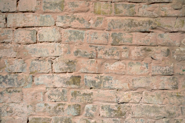 Muro di pietra del mattone del primo piano del colpo di scherma del territorio della casa