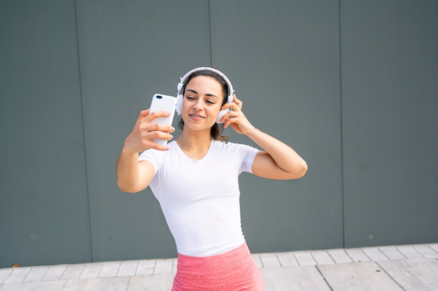 Musica d'ascolto sportiva in cuffia fuori dalla palestra