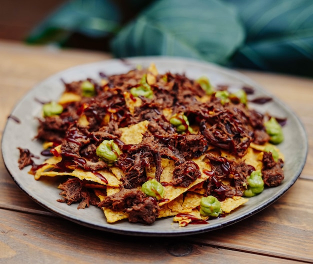 Nachos messicani con carne di manzo e peperoncino sulla tavola di legno