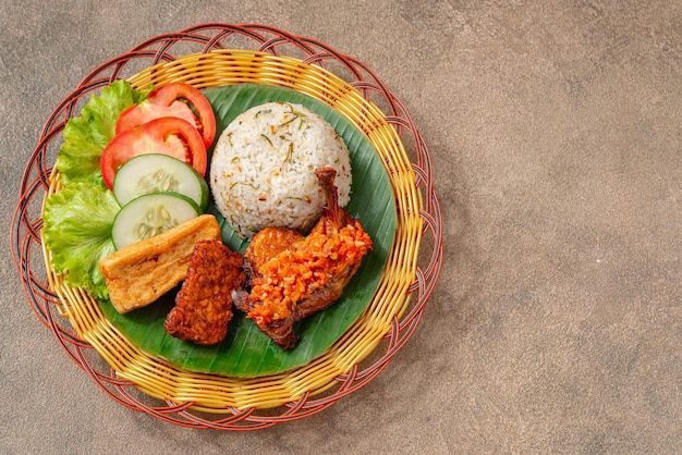 Nasi Jeruk Ayam Geprek è un cibo indonesiano di pollo fritto croccante con sambal bawang caldo e piccante