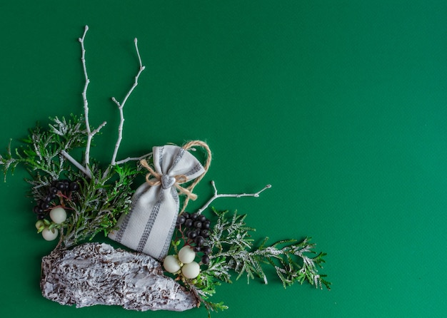 Natale capodanno carta rami di abete sacchetto regalo su uno sfondo verde elegante piatto laici copia spazio in alto...