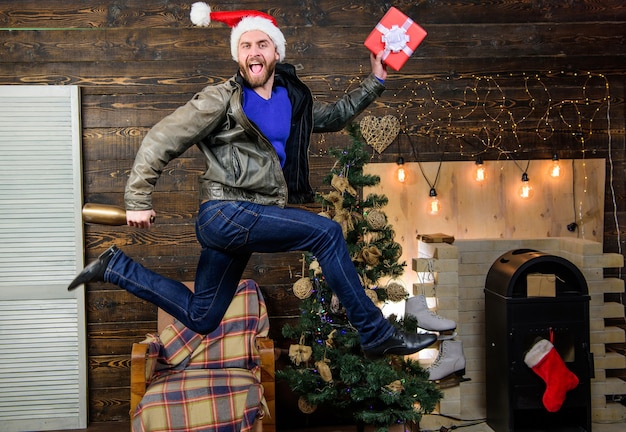 Natale sta arrivando. Diffondi felicità e gioia. Ragazzo barbuto in movimento salto. Regalo di natale di consegna. Hai ancora tempo. Servizio di consegna. Consegna regali. Il cappello da Babbo Natale si affretta a consegnare il regalo in tempo.