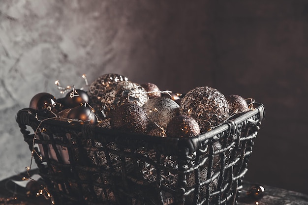 Natale vintage, giocattoli di capodanno e decorazioni nel cesto su un tavolo di legno marrone con ghirlande, spazio per le copie