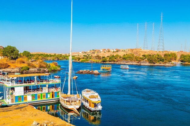 Navi turistiche sul fiume Nilo vicino al famoso villaggio nubiano al tramonto Aswan Egitto 17 ottobre 2023