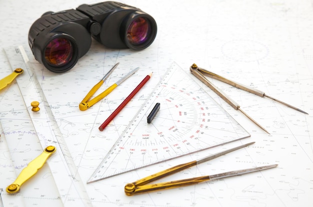 navigation tools are on the navigation map plotter divider ruler binoculars and pencil