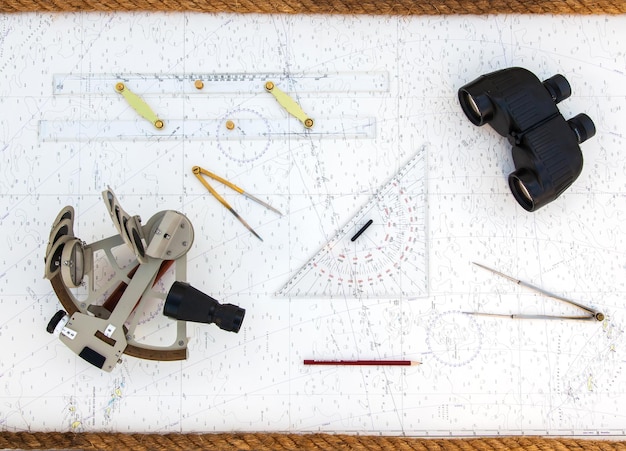 navigation tools are on the navigation map sextant plotter divider ruler and binoculars