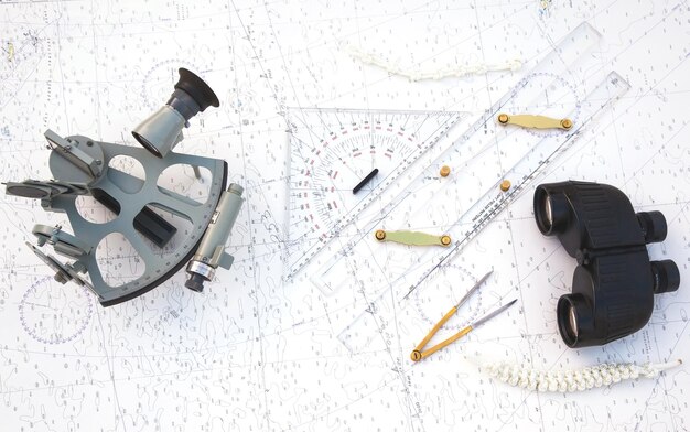 navigation tools are on the navigation map sextant plotter divider ruler and binoculars