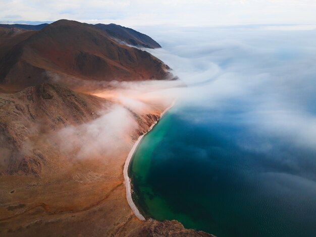 Nebbia sulla riva del lago Baikal e sulle montagne. Vista aerea del drone. Lago Baikal, Siberia, Russia. Bellissimo paesaggio primaverile