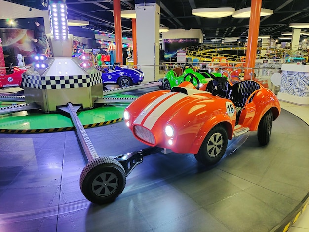 Nel parco dei divertimenti c'è una giostra per bambini a forma di macchina che viaggia in cerchio