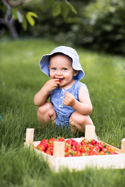 Neonata che mangia le fragole in natura