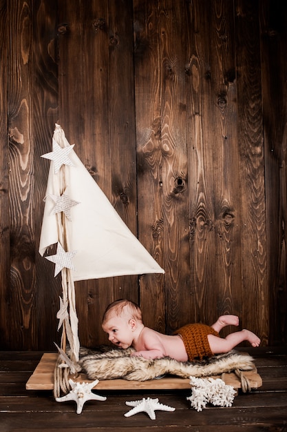 neonato, studio fotografico su uno sfondo di legno