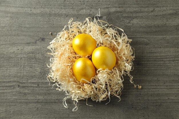 Nido con le uova di Pasqua sulla vista superiore del fondo di legno