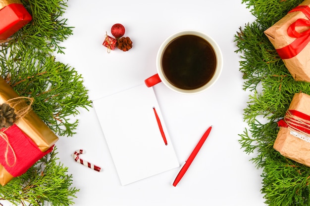 Notebook con penna accanto a tazza di caffè e regali