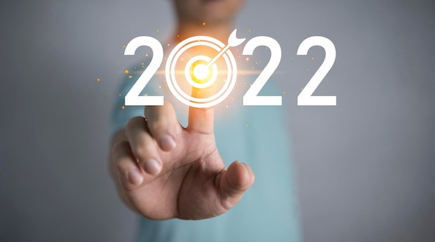 Obiettivi e obiettivi aziendali Idee per il nuovo anno 2022 Dita sul bersaglio per il business del nuovo anno 2022