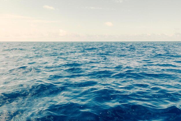 Oceano blu, superficie dell'acqua e cielo blu