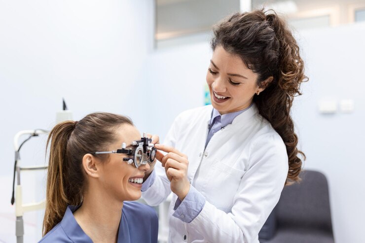 Oculist trying to improve vision of young pretty girl Working with medical devices for eye health