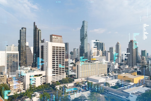 Ologramma del grafico azionario finanziario sulla vista panoramica della città del centro affari di Bangkok nel sud-est asiatico Il concetto di transazioni internazionali Doppia esposizione