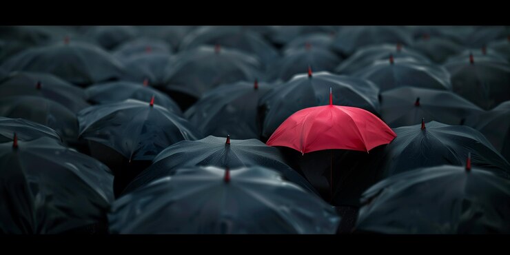 Ombrello rosso tra molti neri Metafora individualità Concetto personalità unica