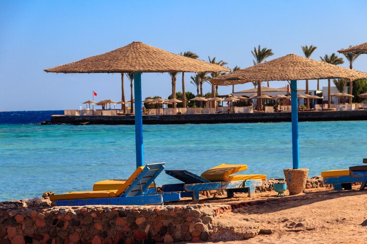Ombrelloni e sdraio sulla spiaggia tropicale. Concetto di riposo, relax, vacanze, resort