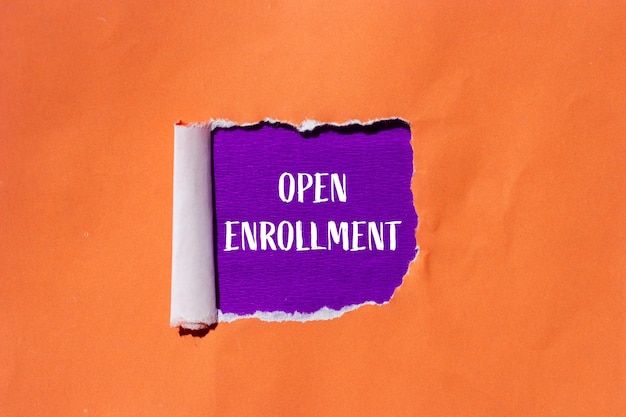 Open enrollment words written on ripped orange paper with purple background Conceptual open enrollment symbol Copy space