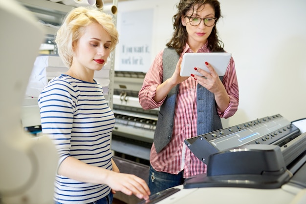 Operatori di tipografia che utilizzano plotter