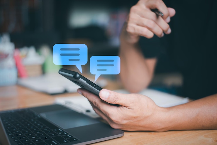 Photo operators use smartphones to chat online messages to provide customer information digital communi
