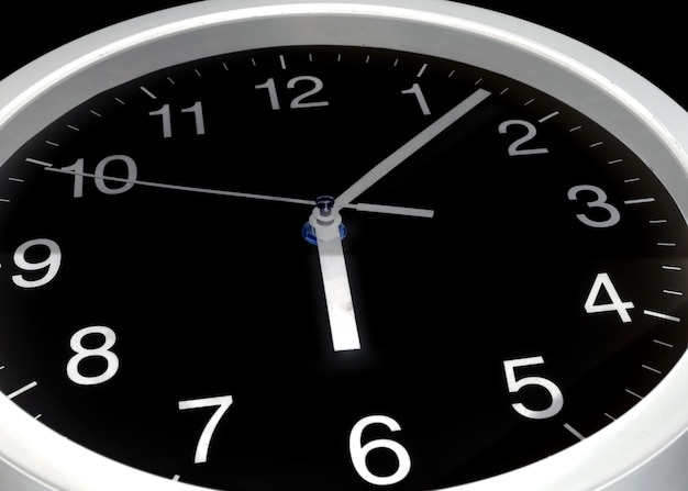 Orologio o tempo astratto, orologio nero e aghi bianchi, sei in punto, sette minuti