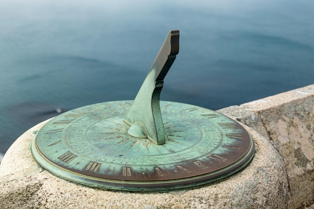 Orologio solare in ottone o rame fissato al muro di pietra del castello