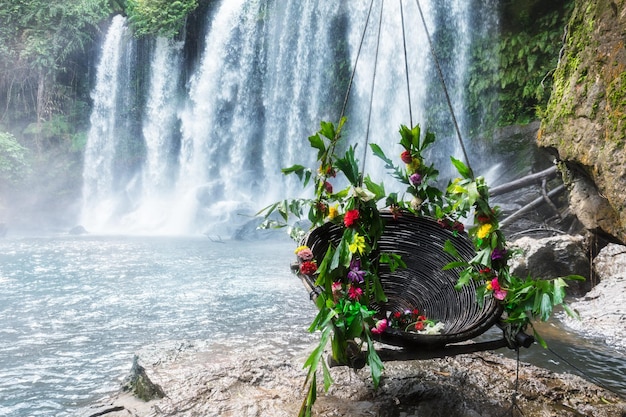 Oscilla con i fiori alla bellissima cascata