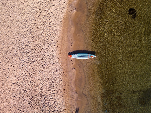 Paddle board sulla spiaggia con sfondo mare