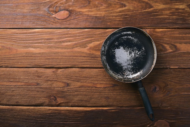 Padella Su fondo in legno nero Vista dall'alto Spazio libero per il testo