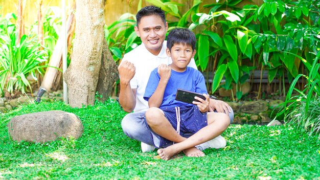 Padre e figlio festeggiano la felicità in giardino