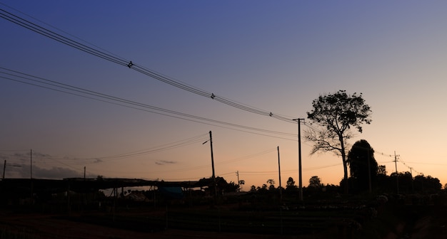 Paesaggio della linea elettrica con sorgere del sole e cielo blu sfondo silhouette immagine